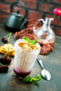white yogurt with berries and cookies, desert in glass