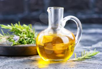 herbal oil in jug and on a table