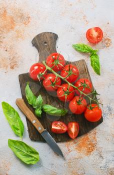fresh tomato with green basil on a table