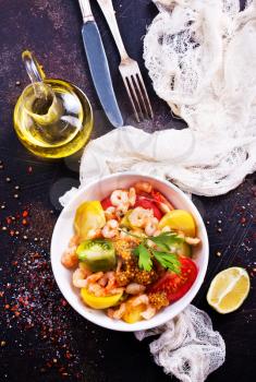 salad with shrimps and vegetables on the plate