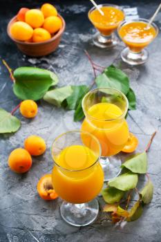 fresh apricot juice in glasses and on a table