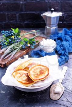 pancakes with blueberry on the plate and on a table