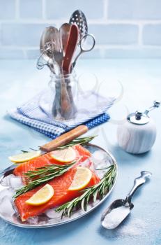 raw salmon with lemon on a table