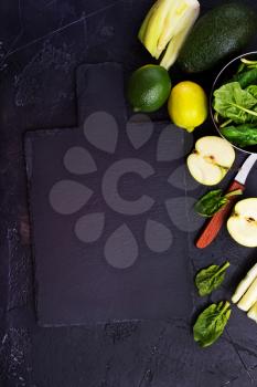 Composition of green vegetables on dark table