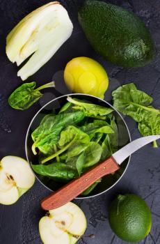 Composition of green vegetables on dark table