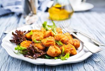 chicken nuggets with salad on plate, fried chicken