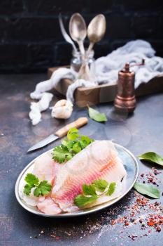 raw fish fillet with aroma spice on plate