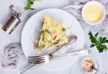 omelette with vegetables on white plate, stock photo