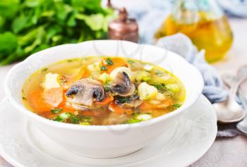 soup with vegetables and mushrooms and fresh greens