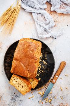 fresh bread on black plate and on a table