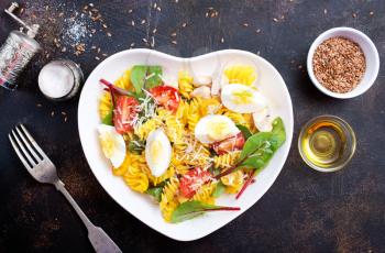 pasta with boiled eggs and cheese in bowl