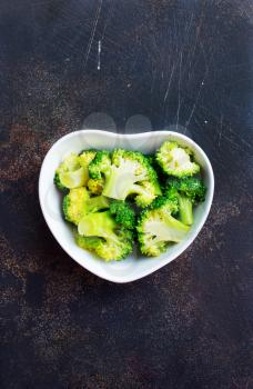 broccoli in white bowl on a table