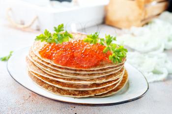 pancakes with red salmon caviar, fried pancakes