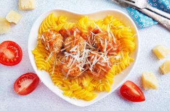 pasta with meat balls and cheese on plate