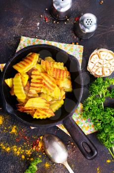 fried potato in pan, fried potato with salt and spice, stock photo