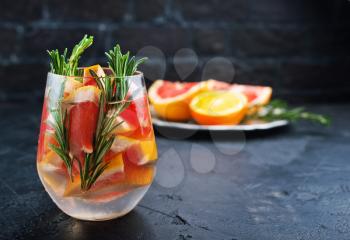 Grapefruit and rosemary gin cocktail, refreshing drink with ice.
