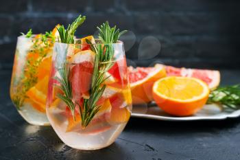 Grapefruit and rosemary gin cocktail, refreshing drink with ice.