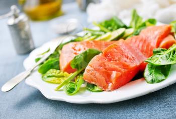 salmon with lemon and fresh spinach, diet food