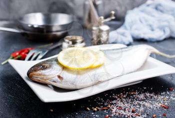 raw fish with fresh lemon on plate