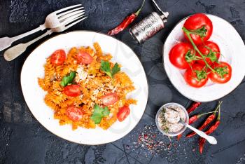boiled pasta with tomato sauce and grated cheese