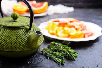 Tea with citrus in teapot, teapot with tes