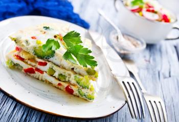 omelette with vegetables on plate on a table