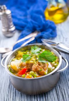 vegetable soup with meatballs in metal bowl