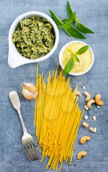raw pasta cheese and pesto sauce in bowl