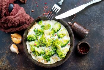 Omelette of eggs, broccoli, cheese in metal pan, baked in pan