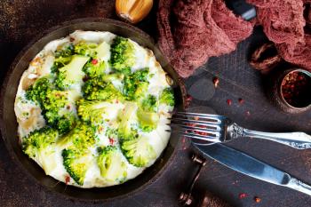 Omelette of eggs, broccoli, cheese in metal pan, baked in pan