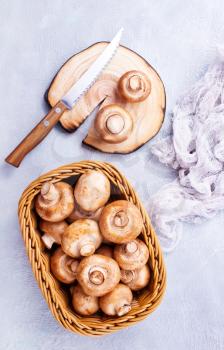 basket of champignon mushrooms on old  table