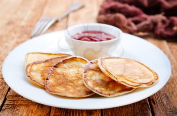 pancakes with jam on plate on a table
