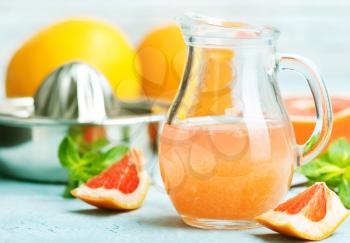 juice and  fresh grapefruit on a table