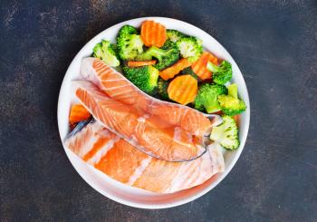 salmon with vegetable salad on white plate