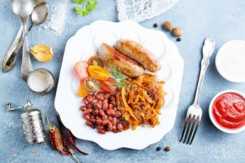 fried cabbage with fried sausages and tomato sauce