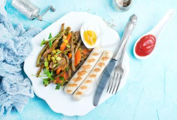 sausages and vegetables for dinner on plate