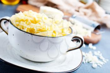 boiled noodles with grated cheese in bowl