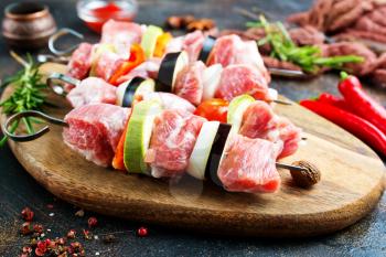 raw kebab with meat and vegetables , meat kebab with eggplant and other vegetables