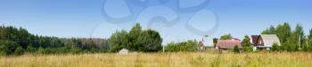 Wonderful summer panoramic view of the village and meadow