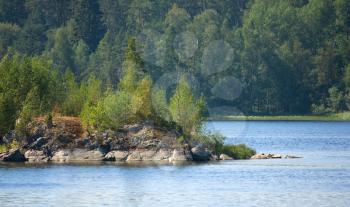 Ladoga lake with island under summer sun light close-up view