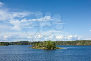 Ladoga lake with small island under summer sunset light panoramic view