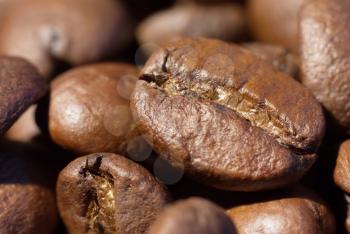 Roasted brown coffee beans close-up macro photo natural food background, selective focue, shallow depth of field.