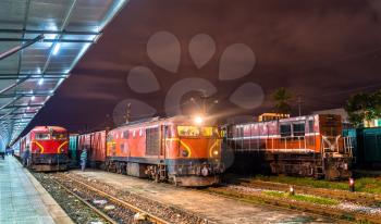 Locomotives with a passenger and a freight trains at Da Nang station in Vietnam