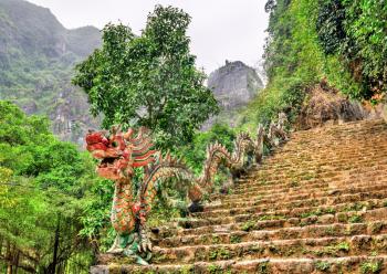 Dragon statue as banister for a stariway leading to Hang Mua viewpoint at Trang An in Vietnam