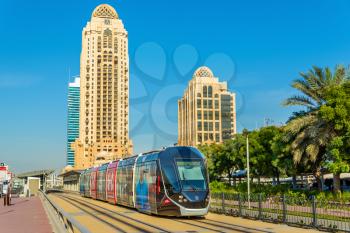 Alstom Citadis 402 tram on December 31, 2015 in Dubai, UAE. The system is wireless as it uses a ground-level power supply