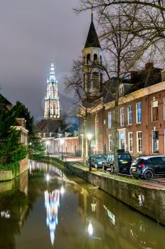 Traditional Dutch buildings along a canal in Amersfoort at night. The Netherlands