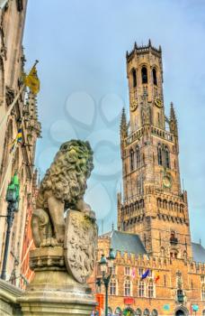 Lion Statue and the Belfry of Bruges, a medieval bell tower in West Flanders Province of Belgium