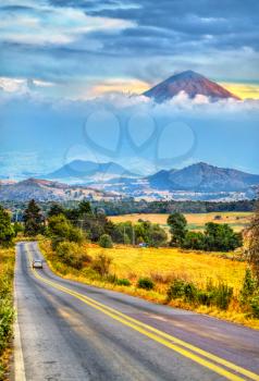 Road with the Popocatepetl Volcano in the background, Mexico