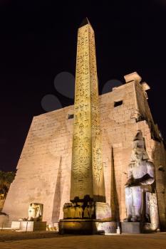 The red granite obelisk at entrance of Luxor Temple - Egypt