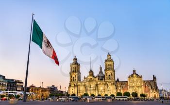 Flagpole and the Metropolitan Cathedral of the Assumption of Virgin Mary in Mexico City, the capital of Mexico